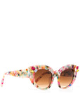 side view of multi-coloured cat-eye sunglasses with gradient brown lenses and gemstone embellishments on the frame corners, set against a white background