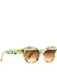 Colorful sunglasses with a translucent multicolored frame and gradient brown lenses, featuring a stylish design and the brand name "MAUDE" on the side.