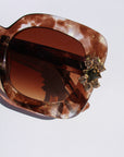 Aftersun ~ Medium sized square sunglasses in brown acetate with golden shimmer and bold crystal flower details