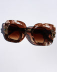 Aftersun ~ Medium sized square sunglasses in brown acetate with golden shimmer and bold crystal flower details
