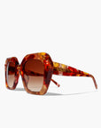 Tortoiseshell sunglasses with brown lenses on a white background
