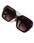 Tigers Eye ~ Oversized oval sunglasses in silver glitter tort acetate with coffee crystal detailing