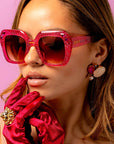 Rosinite ~ Oversized pink oval sunglasses in glitter acetate with fuchsia crystal detailing
