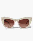 Cat-eye sunglasses with a beige frame and brown lenses on a white background