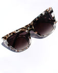Tortelle ~ Sharp cat-eye sunglasses in pearl tortoise shell with micro opal crystal detailing