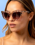 Tortelle ~ Sharp cat-eye sunglasses in pearl tortoise shell with micro opal crystal detailing