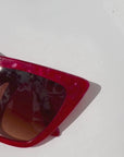 Rubie ~ Sharp cat-eye sunglasses in red marble with micro crystal detailing