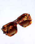 Fire Opal ~ Oversized oval sunglasses in red apricot tort acetate with matching crystal detailing