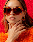 Fire Opal ~ Oversized oval sunglasses in red apricot tort acetate with matching crystal detailing
