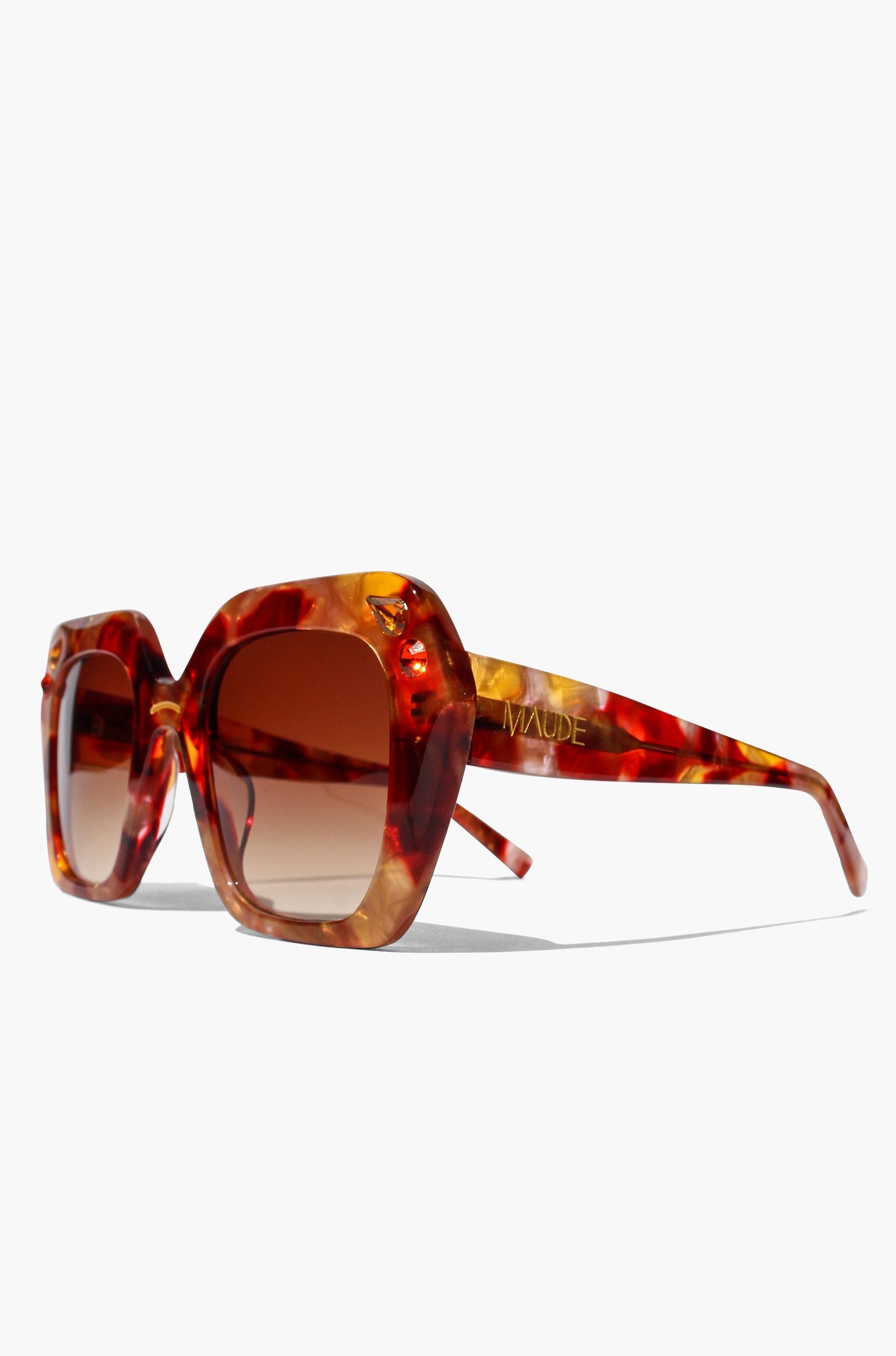 Tortoiseshell sunglasses with brown lenses on a white background