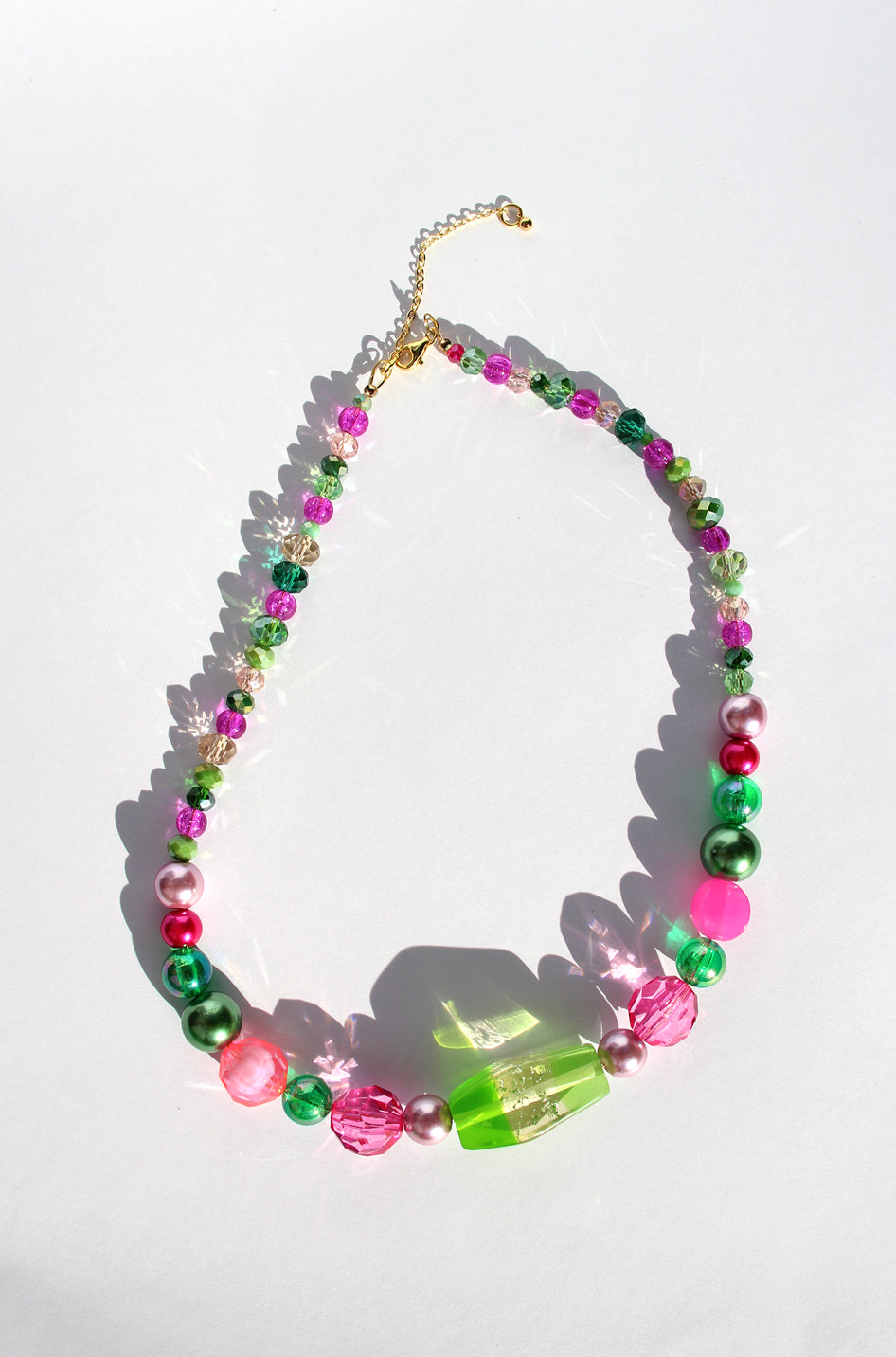 GUAVA GLOW ~ Handmade statement necklace featuring a green glitter centrepiece with emerald green and fuchsia beads
