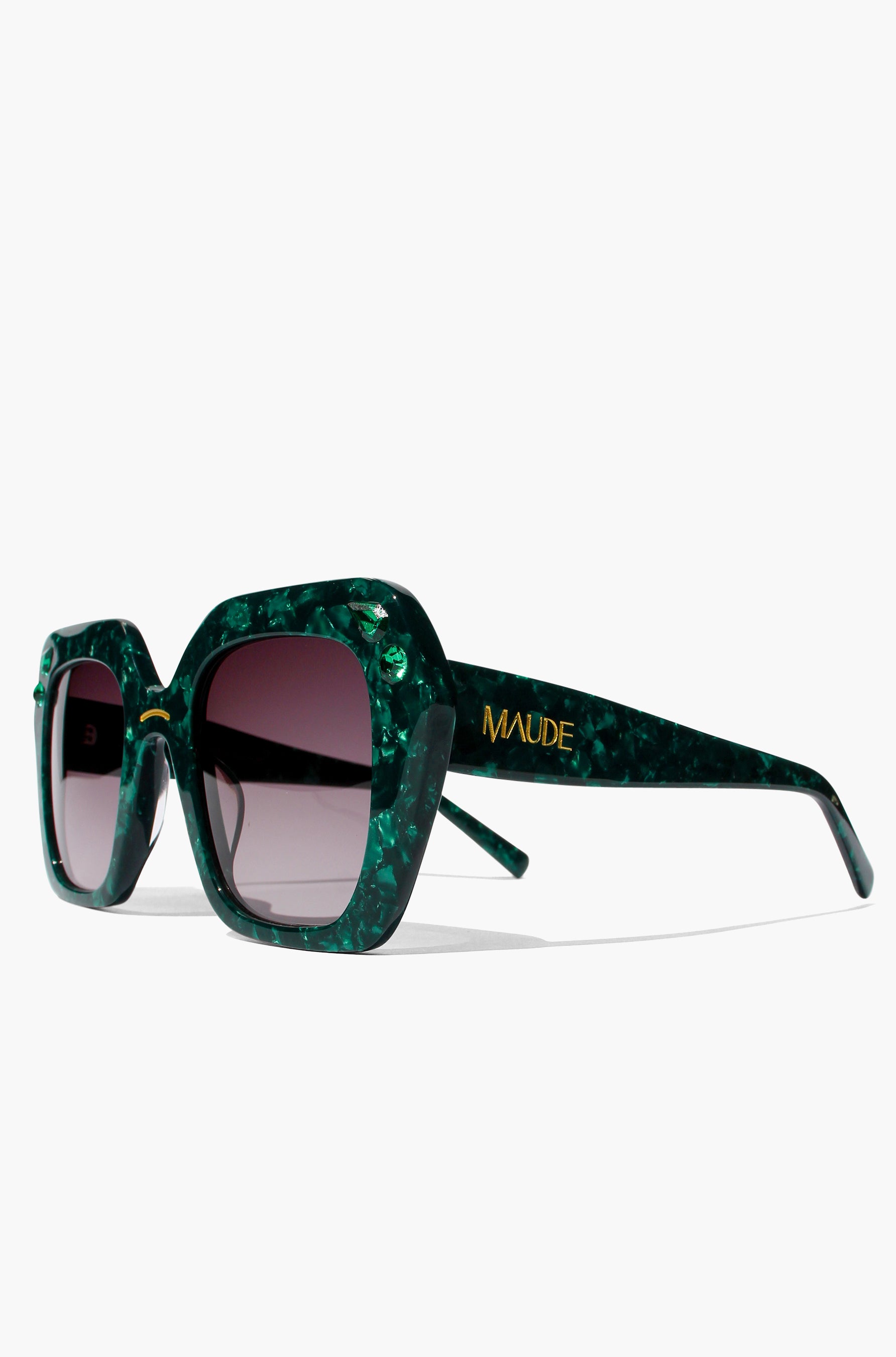 Green sunglasses with a brand name on a white background