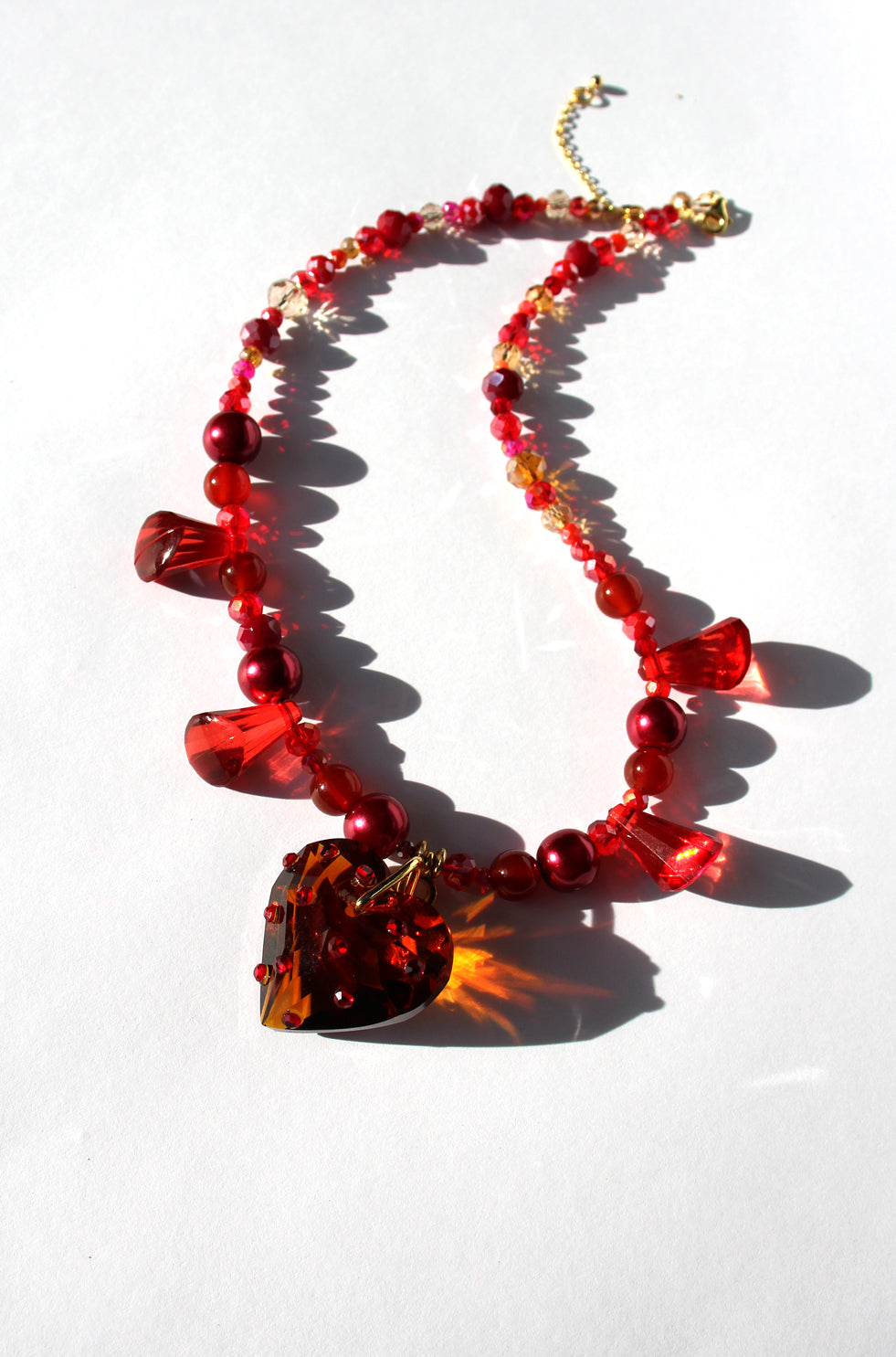 HEARTFLAME ~ Red crystal heart handmade necklace with red chandelier crystals, and rondelle crystals in shades of red