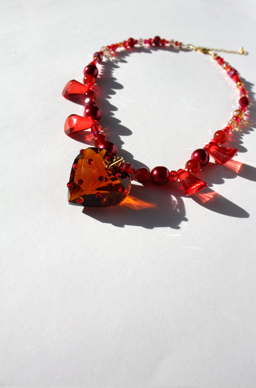 HEARTFLAME ~ Red crystal heart handmade necklace with red chandelier crystals, and rondelle crystals in shades of red