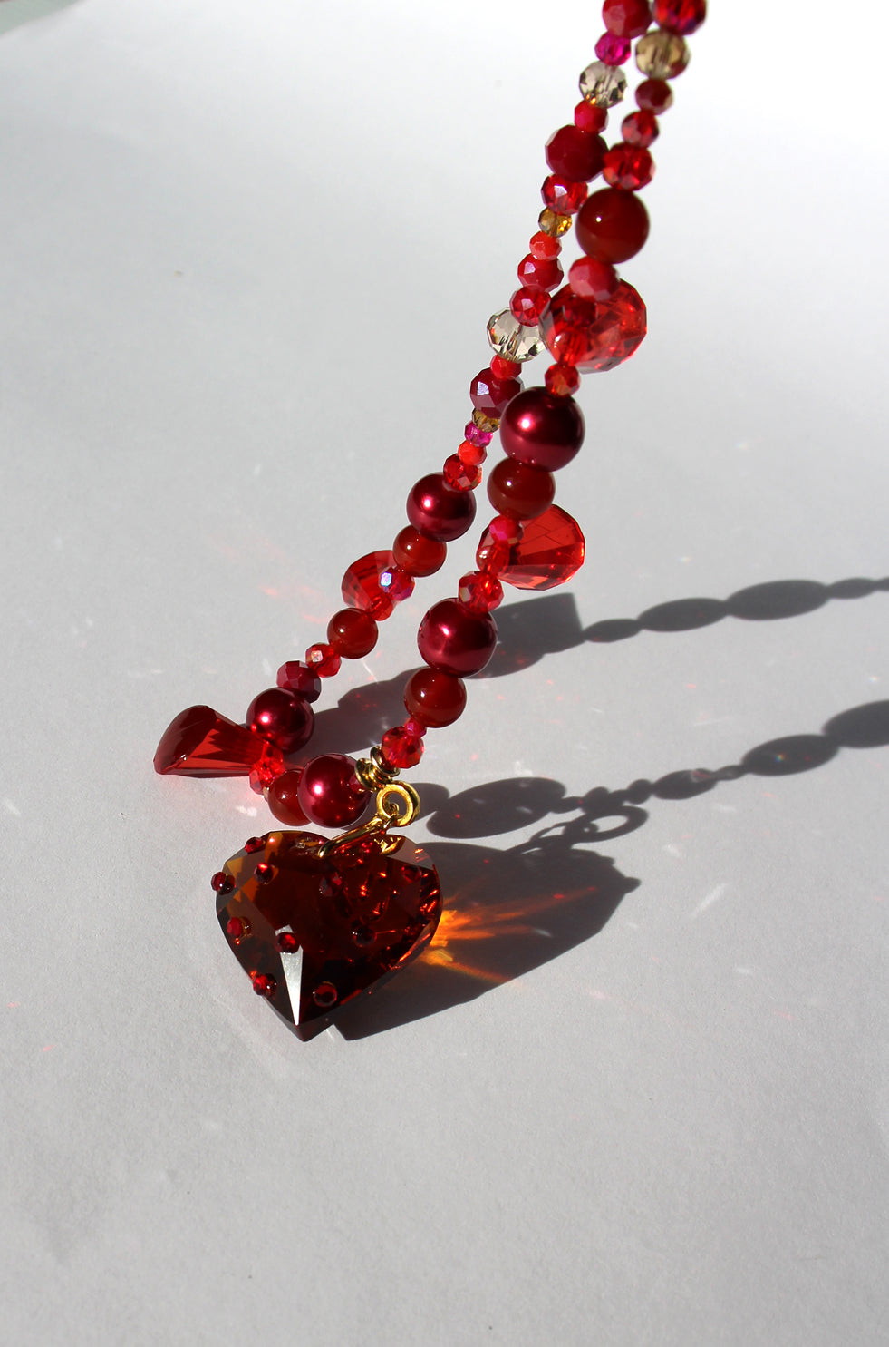 HEARTFLAME ~ Red crystal heart handmade necklace with red chandelier crystals, and rondelle crystals in shades of red
