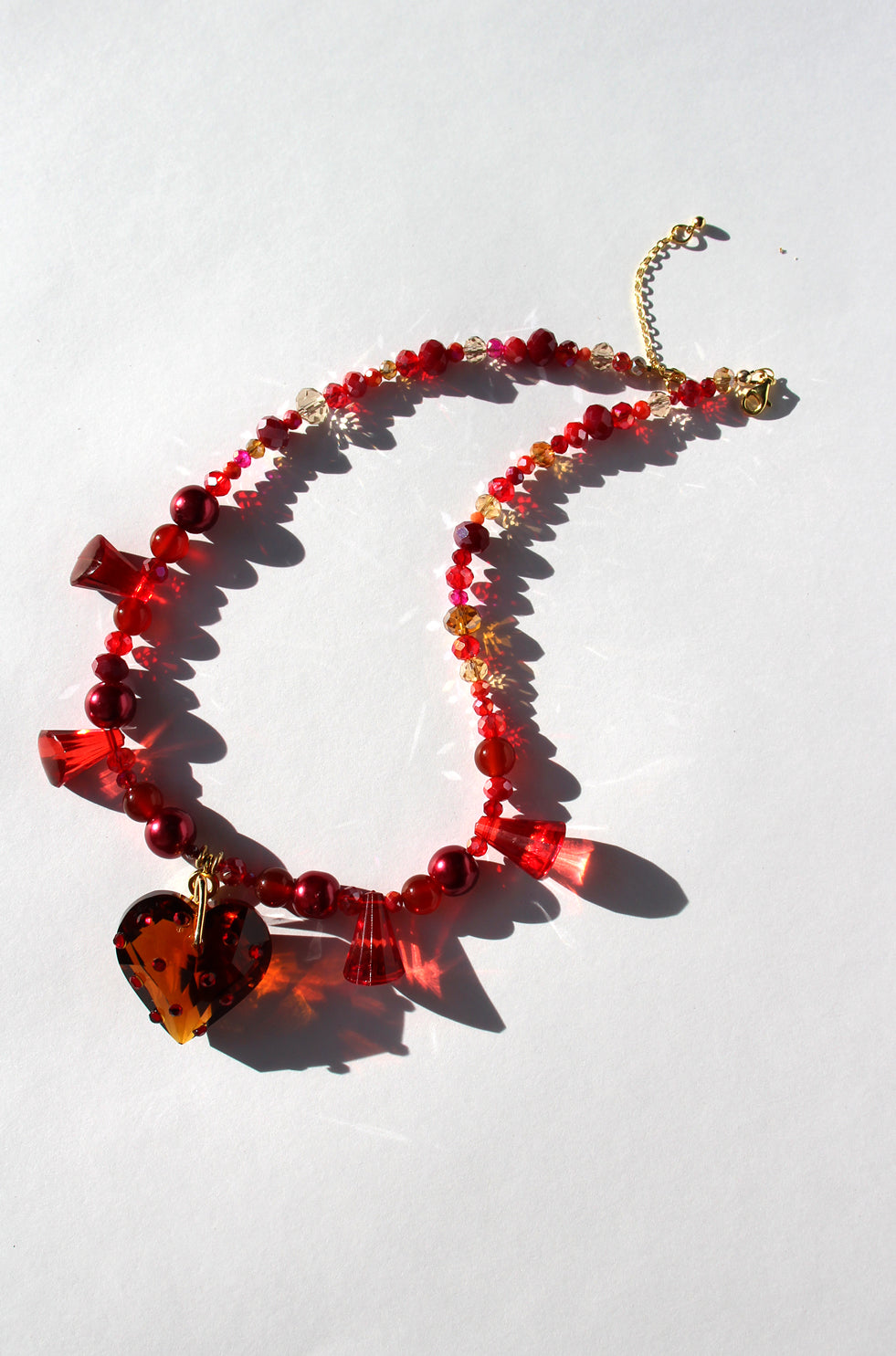 HEARTFLAME ~ Red crystal heart handmade necklace with red chandelier crystals, and rondelle crystals in shades of red