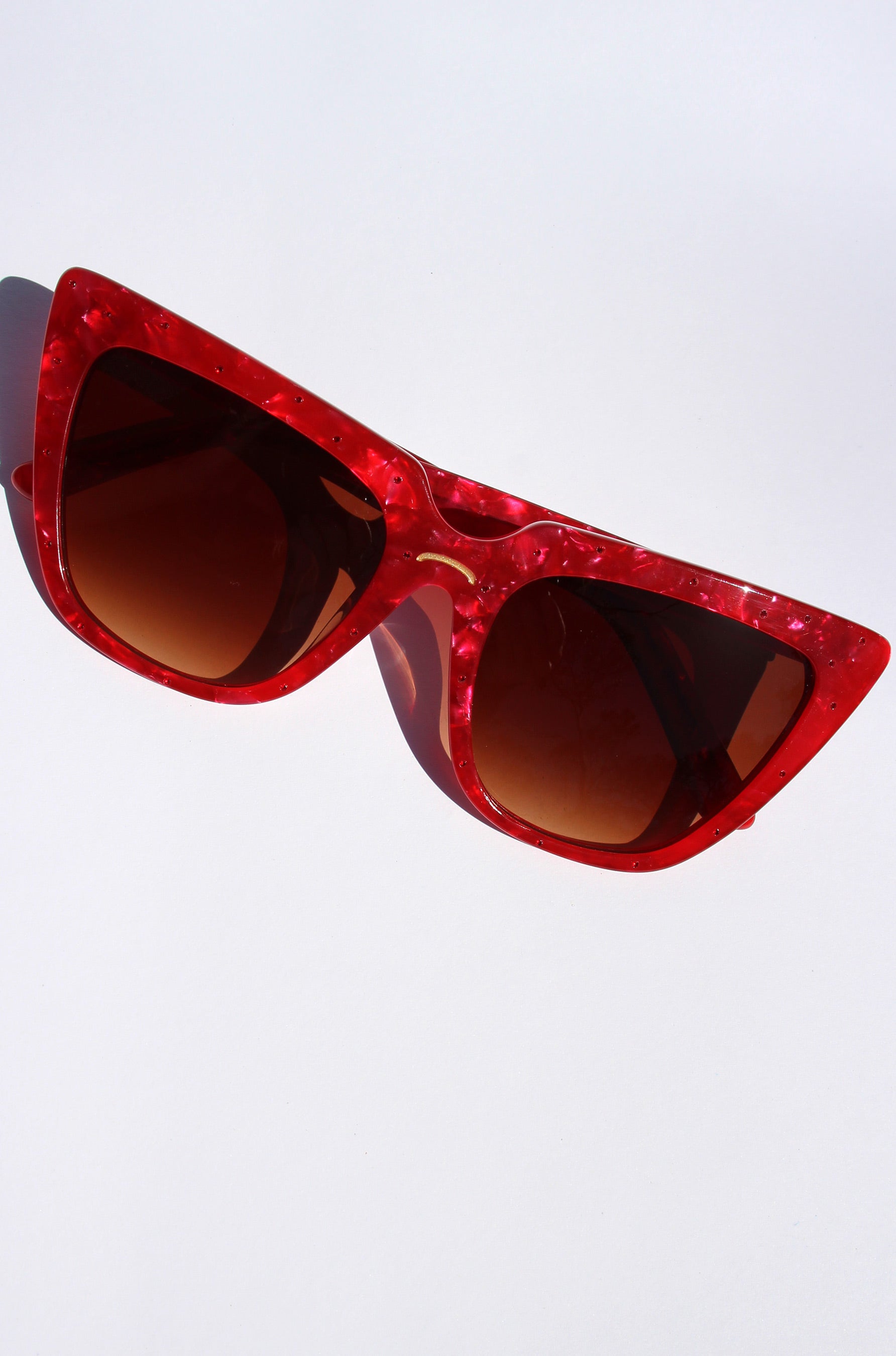 Rubie ~ Sharp cat-eye sunglasses in red marble with micro crystal detailing