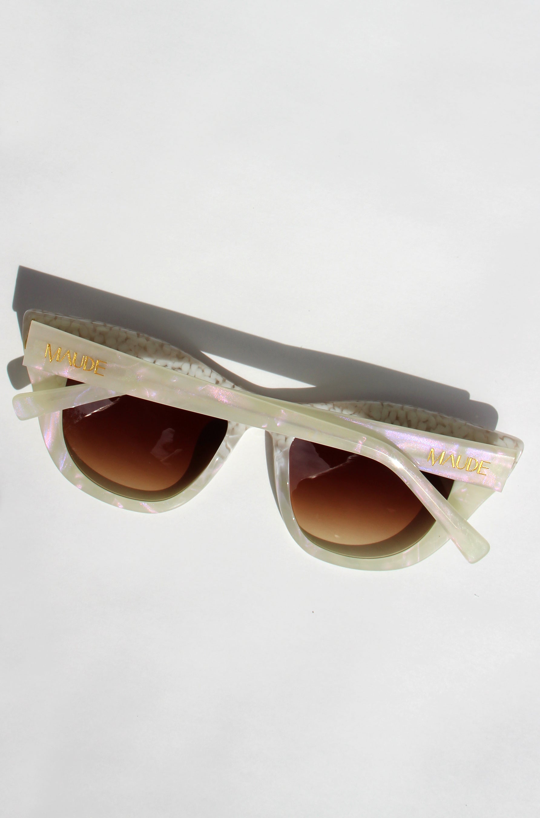 Sunglasses with gradient lenses on a light gray background