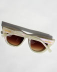 Sunglasses with gradient lenses on a light gray background
