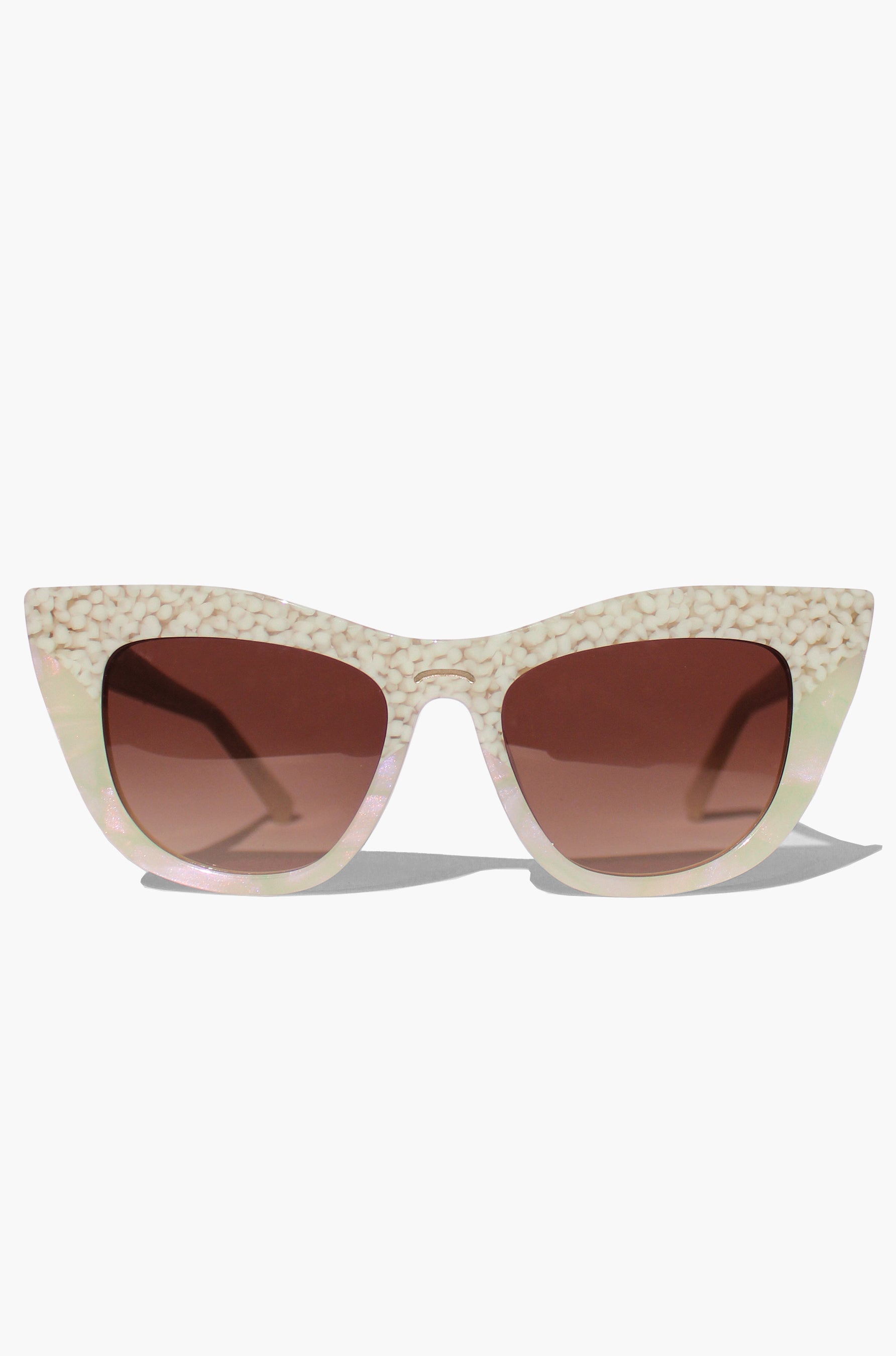 Cat-eye sunglasses with a beige frame and brown lenses on a white background