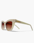 Beige sunglasses with a textured frame on a white background
