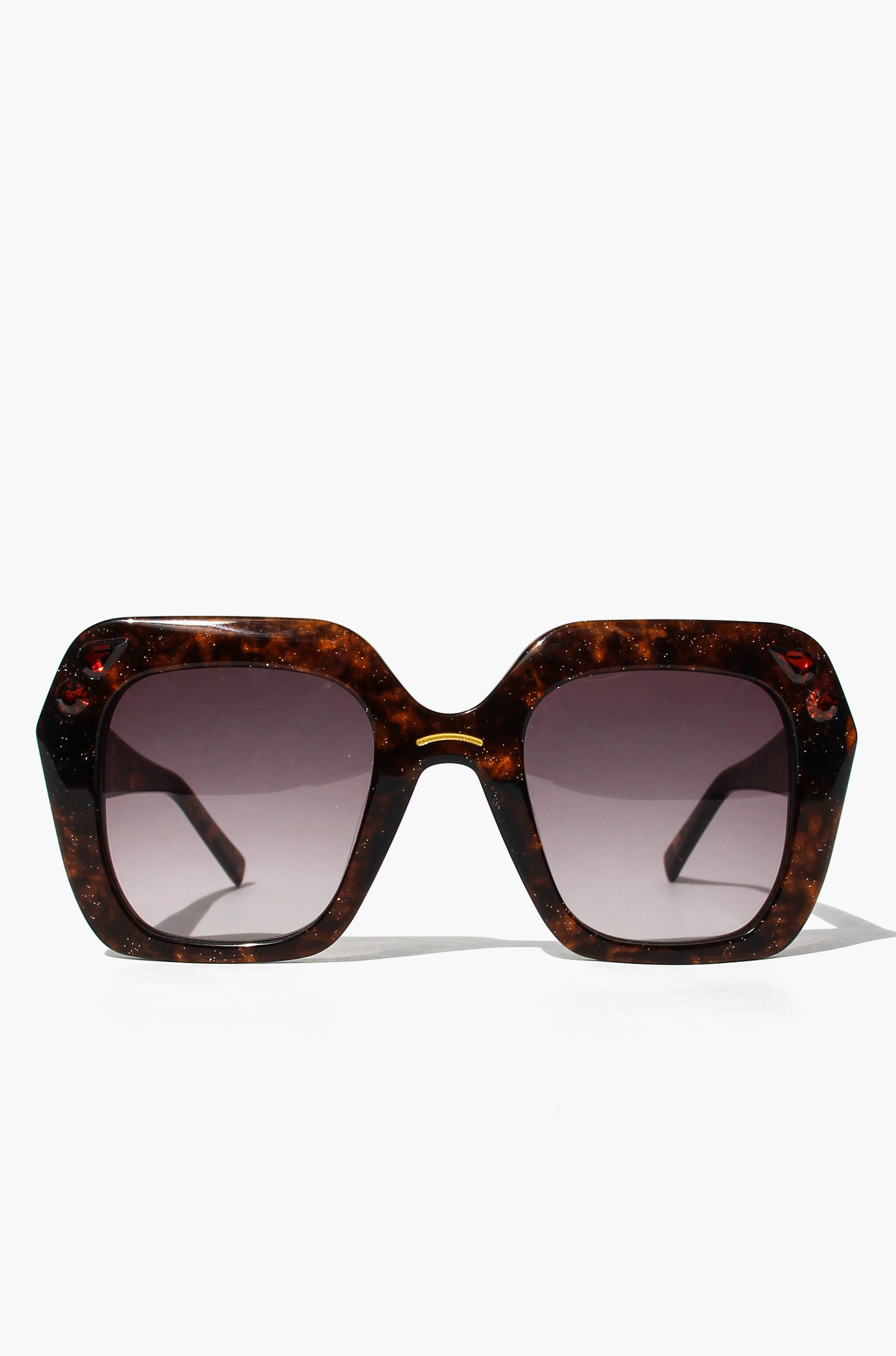 Tortoiseshell sunglasses with dark lenses on a white background