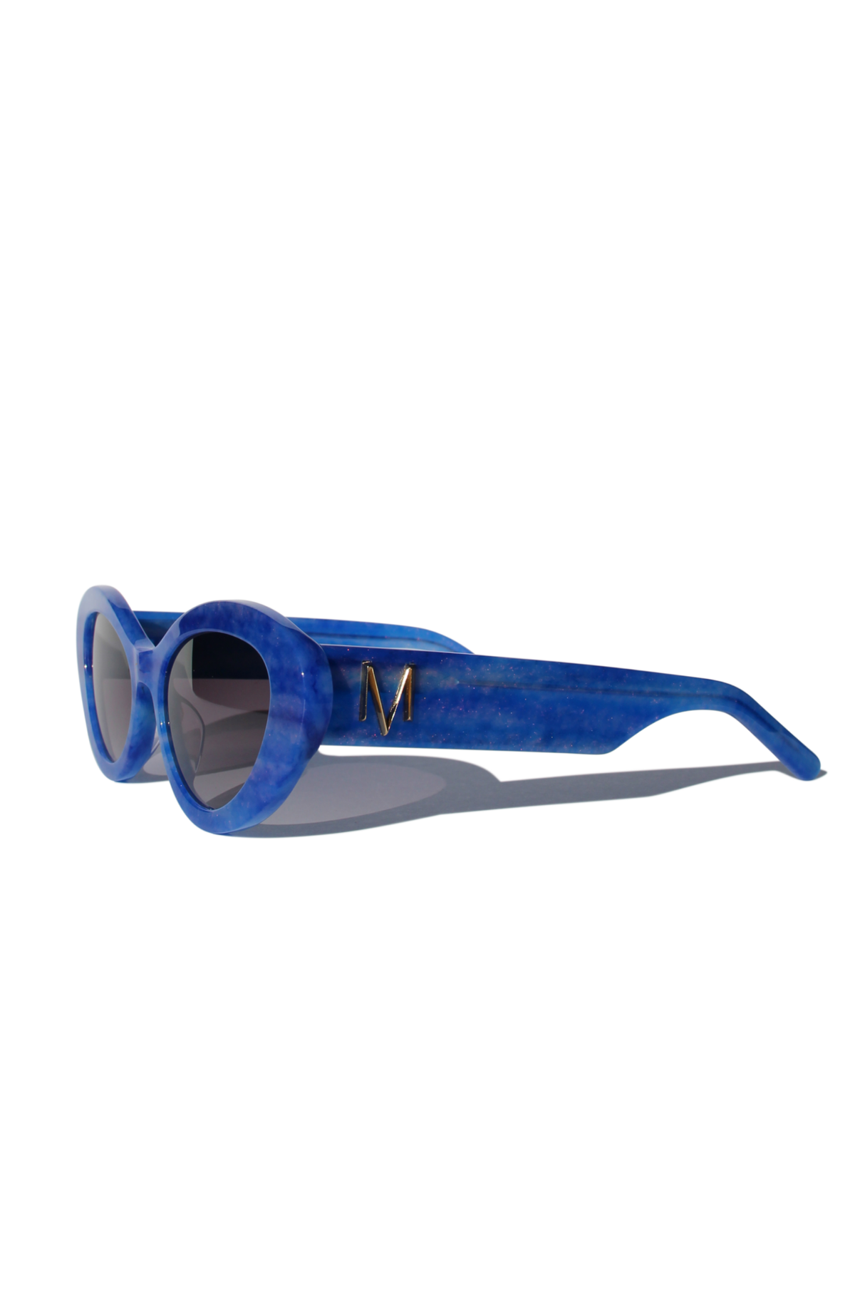 AZURIA ~ Oval shaped sunglasses in a luminous imperial blue with pink shimmer