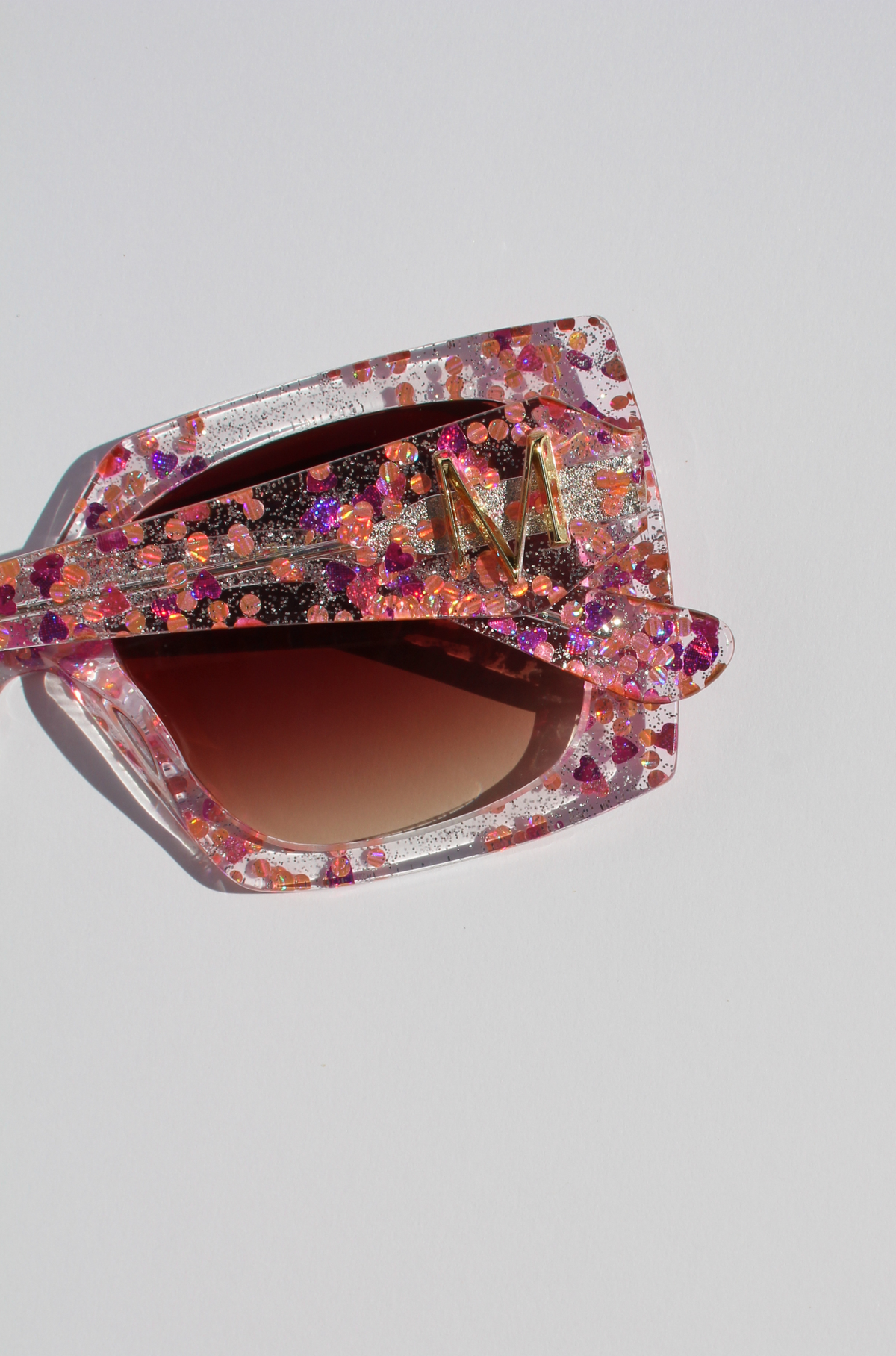 GLITTERATI ~ Square shaped sunglasses in silver glitter with a confetti of pink hearts and peach sequins