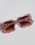 GLITTERATI ~ Square shaped sunglasses in silver glitter with a confetti of pink hearts and peach sequins