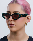GLOWELLA ~ Oval shaped sunglasses in dark green with shimmering emerald tort