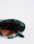 GLOWELLA ~ Oval shaped sunglasses in dark green with shimmering emerald tort