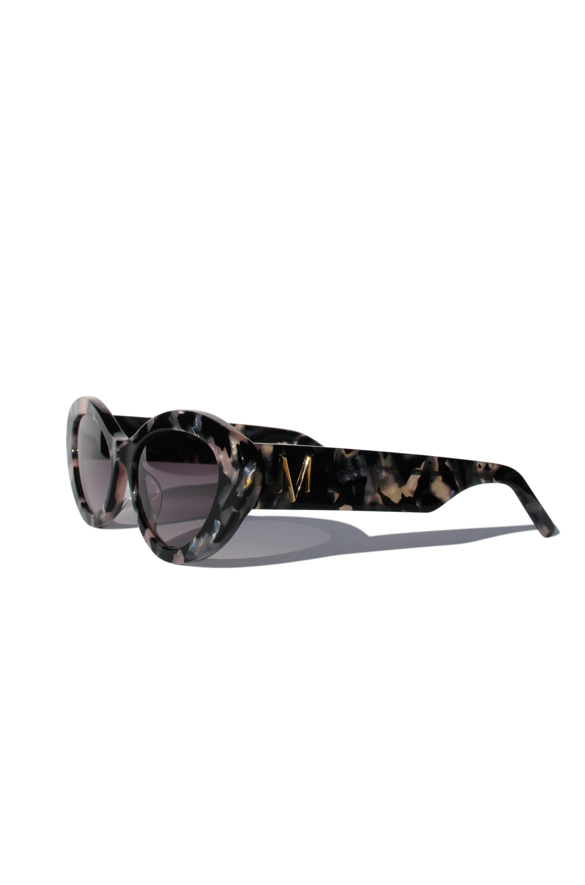 ONYX NOIR ~ Oval shaped sunglasses in marbled black and blush with shimmering turquoise acetate