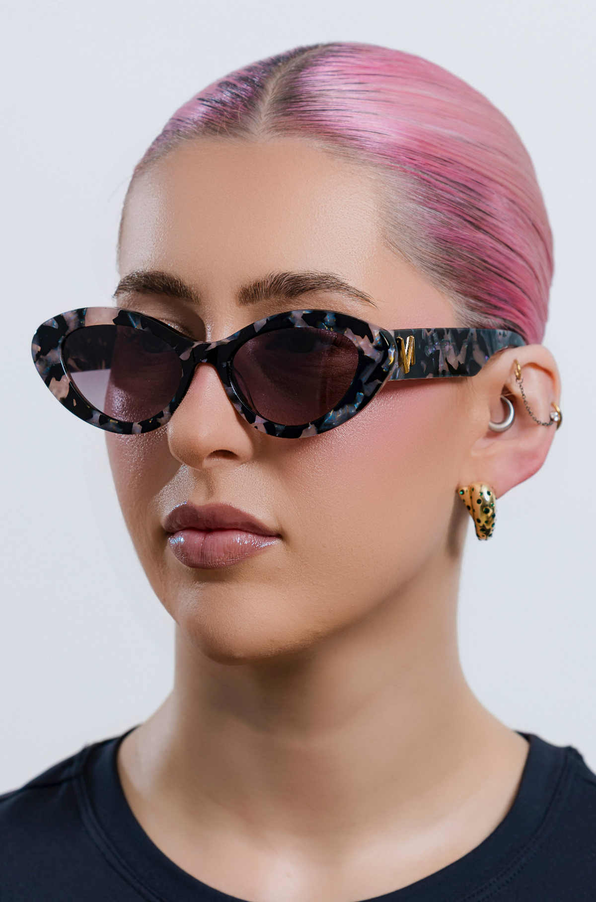 ONYX NOIR ~ Oval shaped sunglasses in marbled black and blush with shimmering turquoise acetate