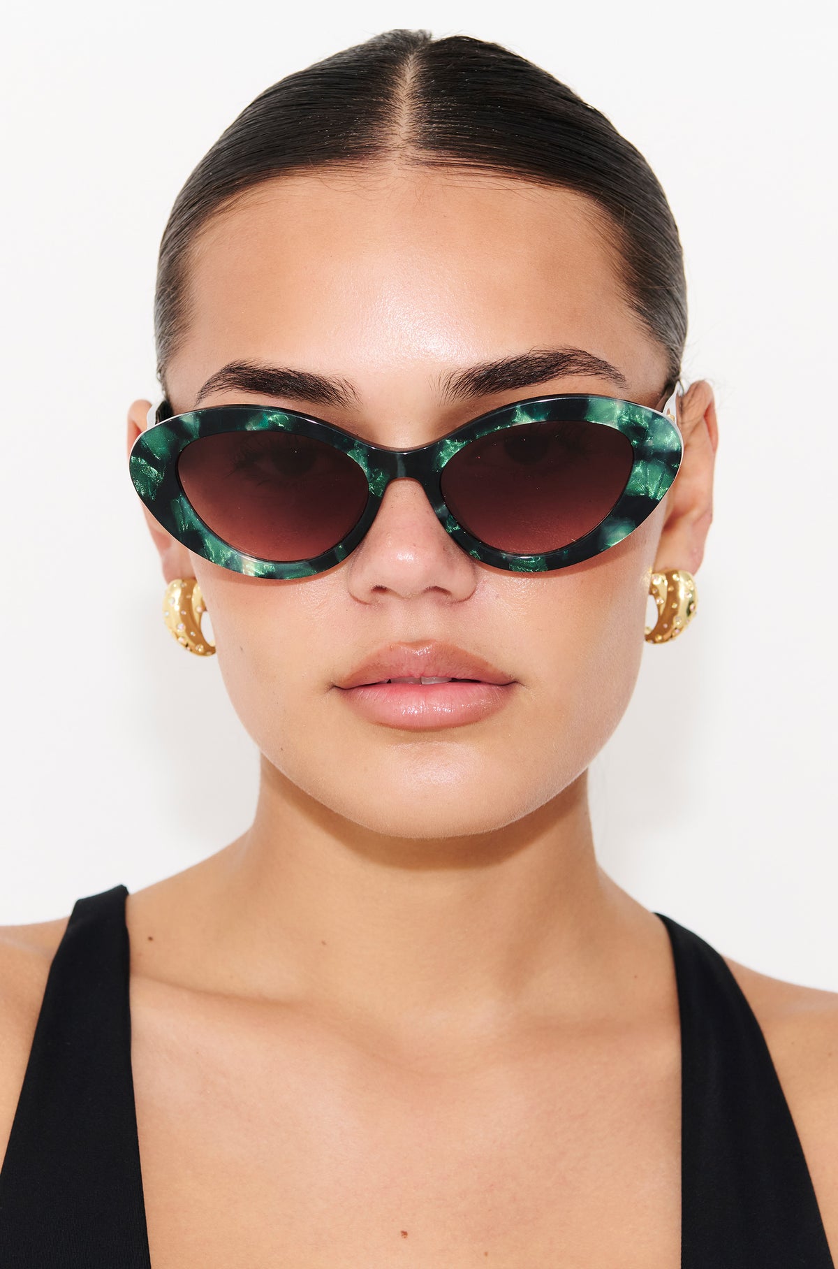GLOWELLA ~ Oval shaped sunglasses in dark green with shimmering emerald tort