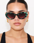 GLOWELLA ~ Oval shaped sunglasses in dark green with shimmering emerald tort