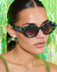 GLOWELLA ~ Oval shaped sunglasses in dark green with shimmering emerald tort