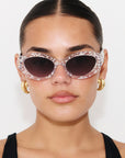 SILVELLE ~ Oval shaped sunglasses in clear acetate sprinkled with iridescent silver love heart sequins