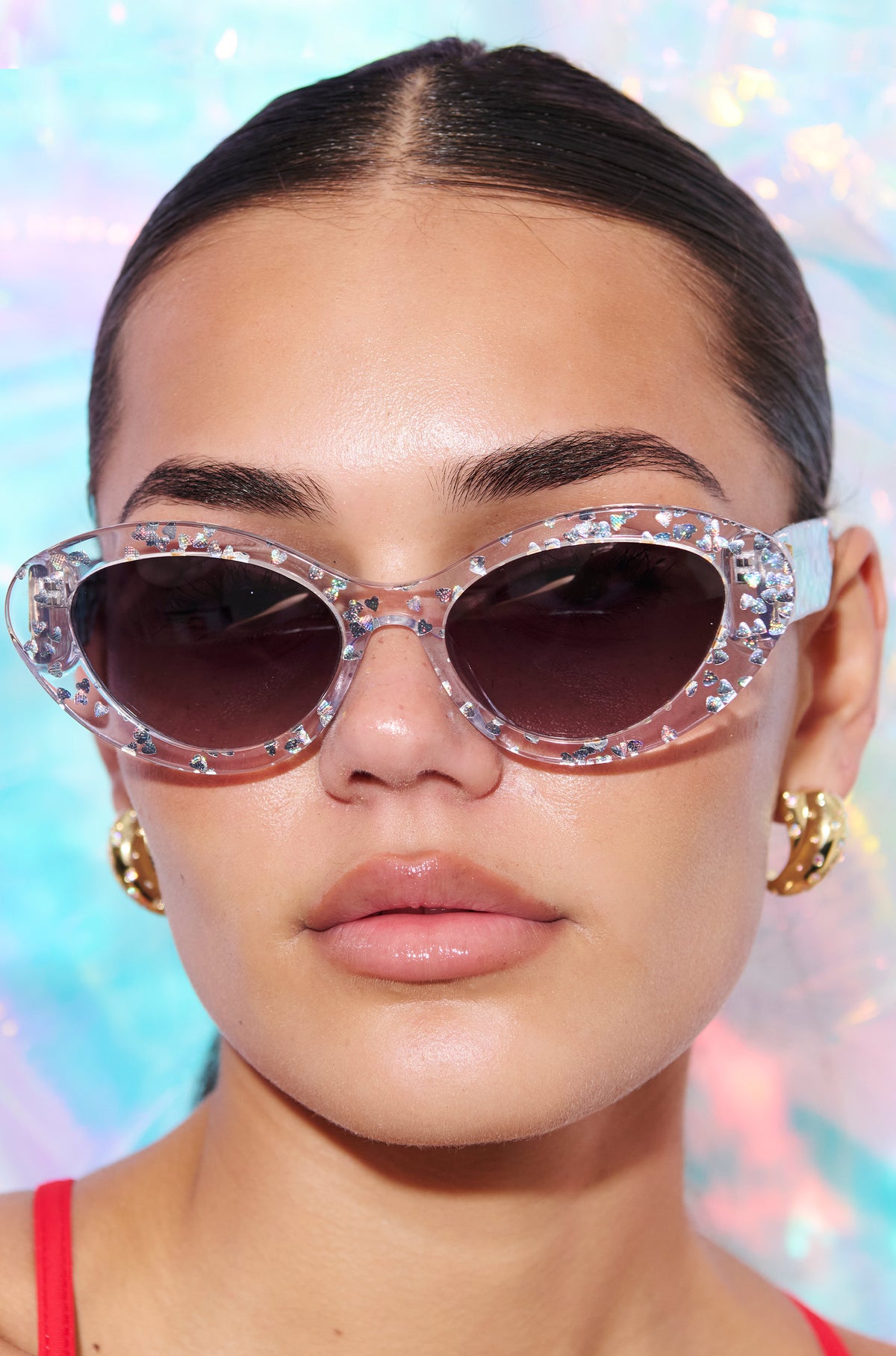 SILVELLE ~ Oval shaped sunglasses in clear acetate sprinkled with iridescent silver love heart sequins