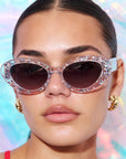 SILVELLE ~ Oval shaped sunglasses in clear acetate sprinkled with iridescent silver love heart sequins