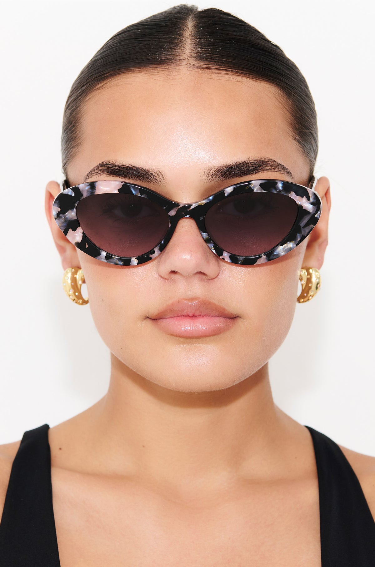ONYX NOIR ~ Oval shaped sunglasses in marbled black and blush with shimmering turquoise acetate