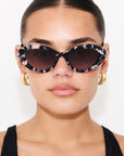 ONYX NOIR ~ Oval shaped sunglasses in marbled black and blush with shimmering turquoise acetate