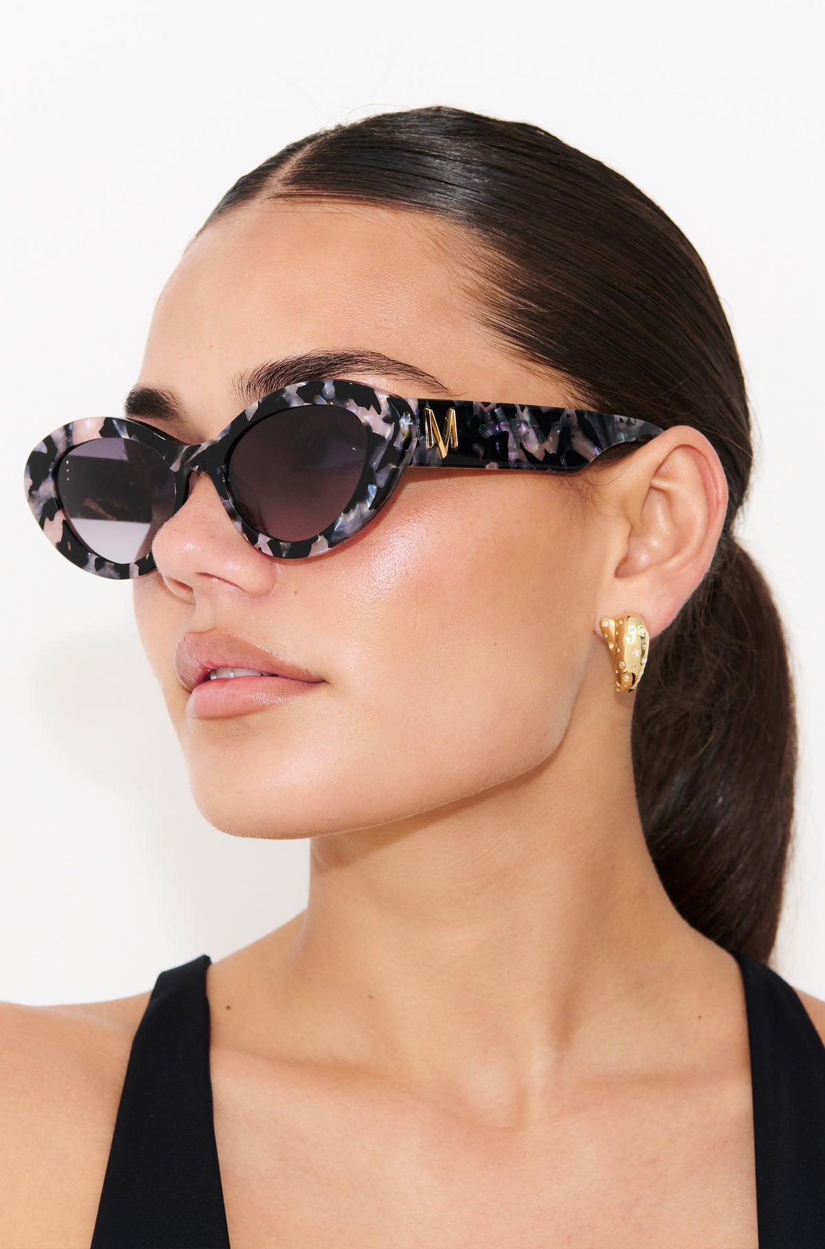 ONYX NOIR ~ Oval shaped sunglasses in marbled black and blush with shimmering turquoise acetate