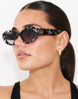 ONYX NOIR ~ Oval shaped sunglasses in marbled black and blush with shimmering turquoise acetate