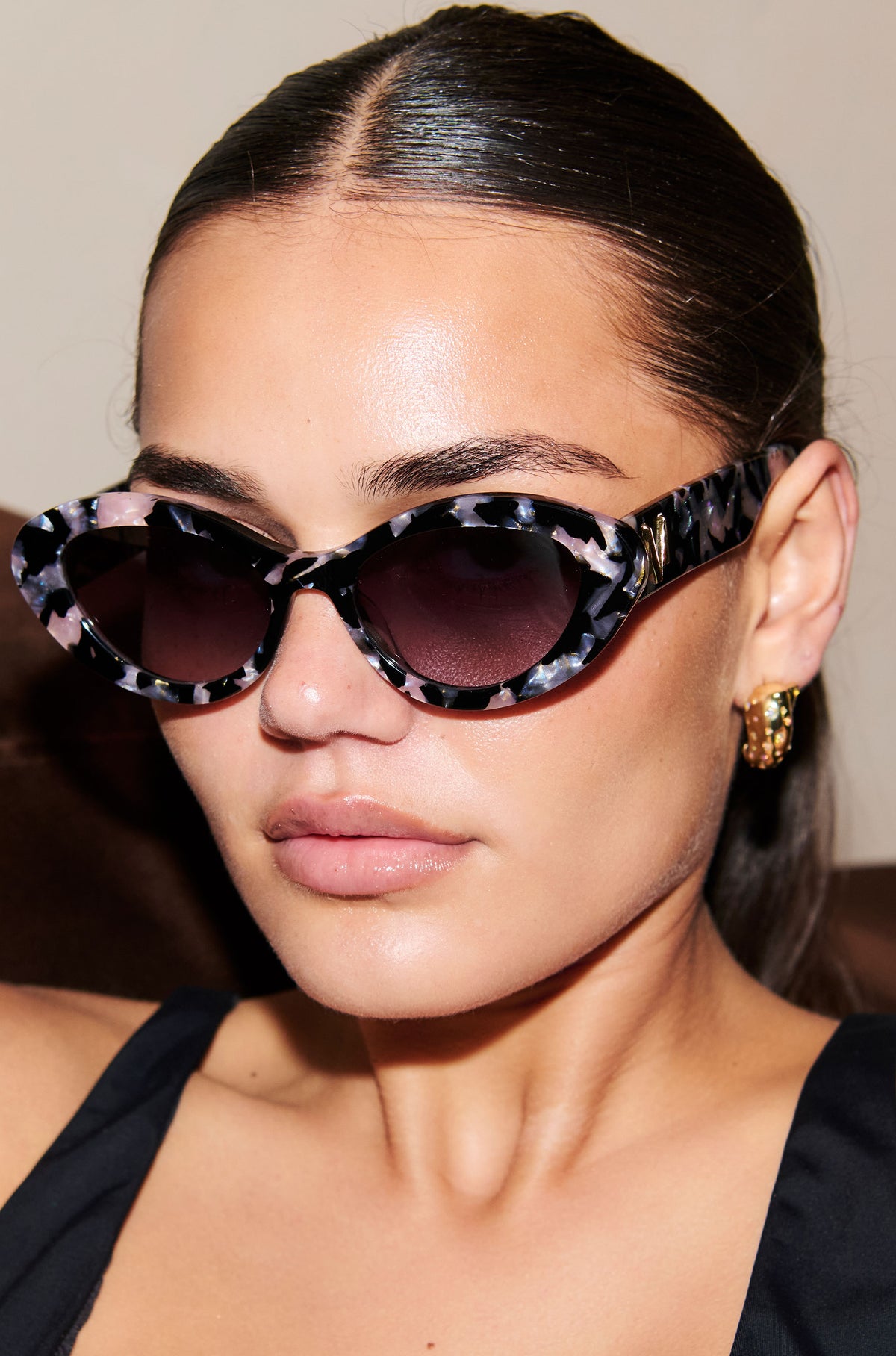 ONYX NOIR ~ Oval shaped sunglasses in marbled black and blush with shimmering turquoise acetate