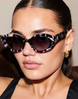 ONYX NOIR ~ Oval shaped sunglasses in marbled black and blush with shimmering turquoise acetate