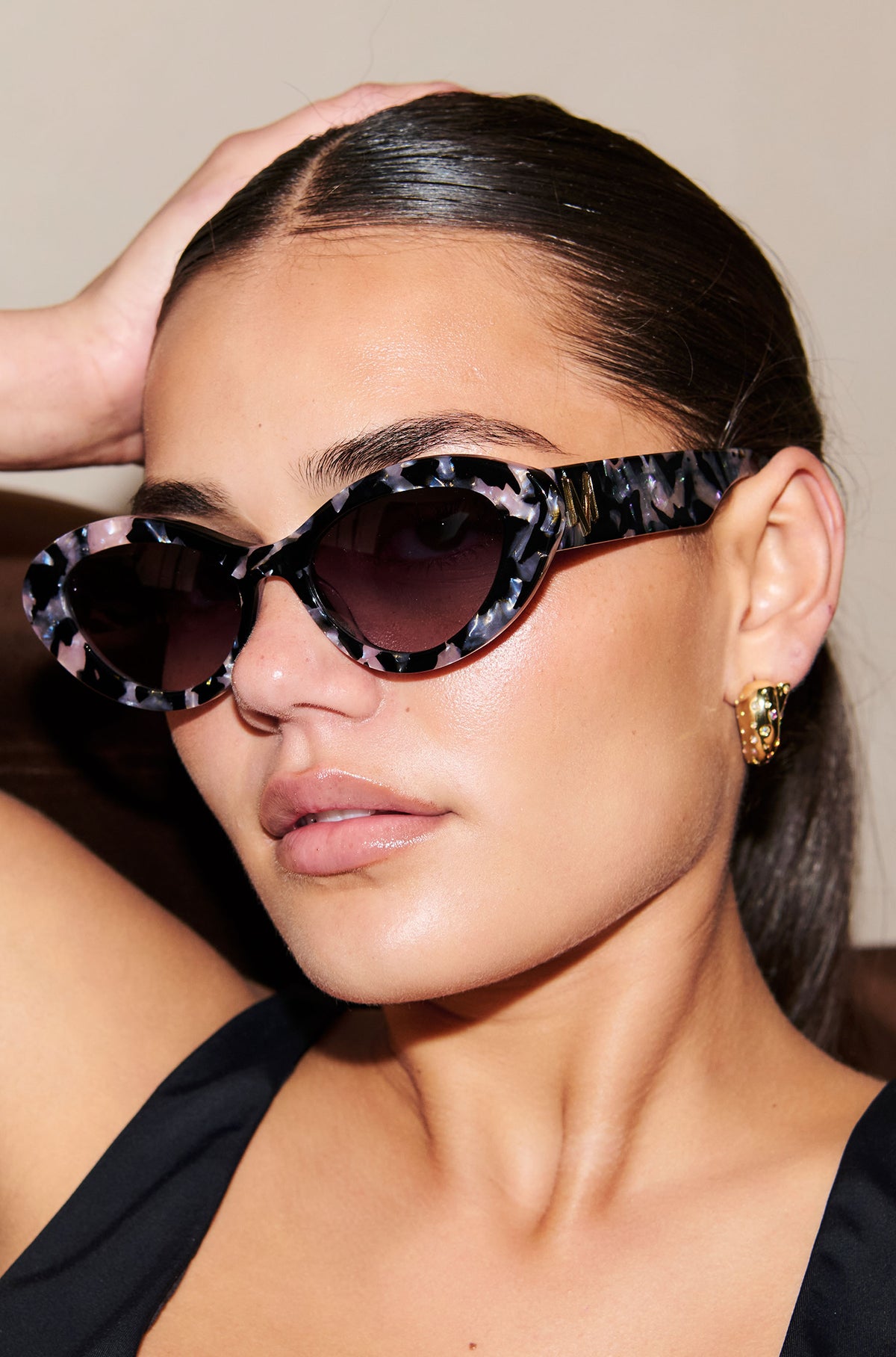 ONYX NOIR ~ Oval shaped sunglasses in marbled black and blush with shimmering turquoise acetate