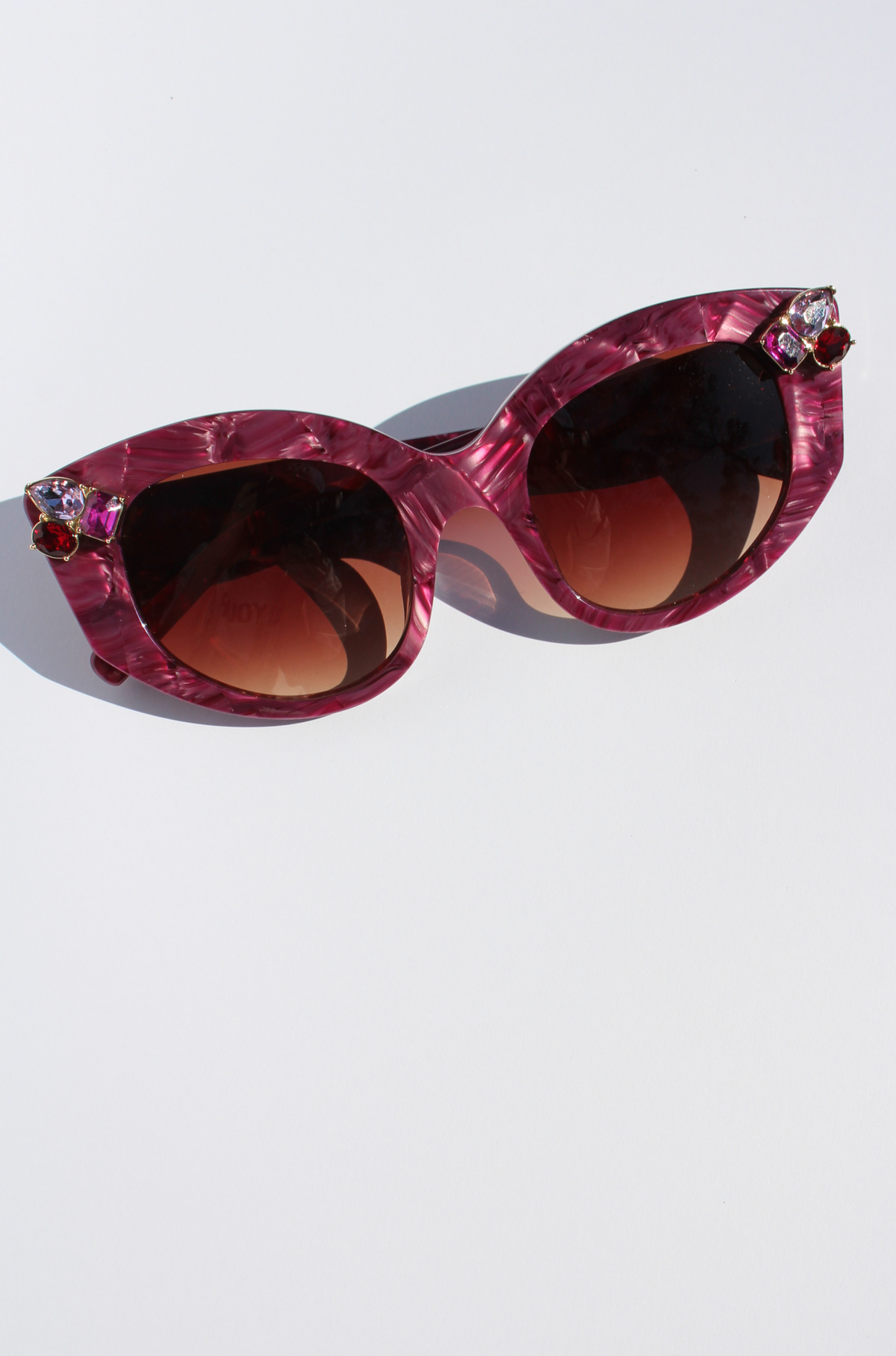 RUBEYE ~ Modern cateye sunglasses in a radiant marbled crimson acetate with crystal embellishments