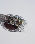 SILVELLE ~ Oval shaped sunglasses in clear acetate sprinkled with iridescent silver love heart sequins
