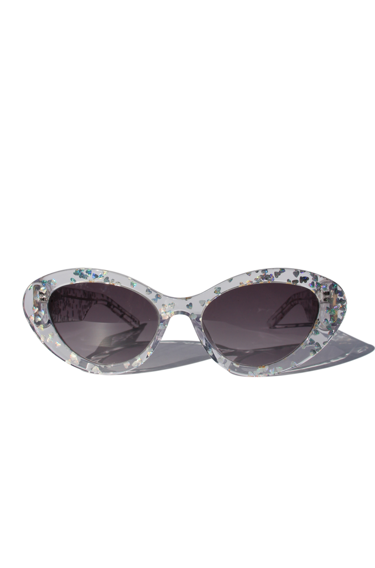 SILVELLE ~ Oval shaped sunglasses in clear acetate sprinkled with iridescent silver love heart sequins
