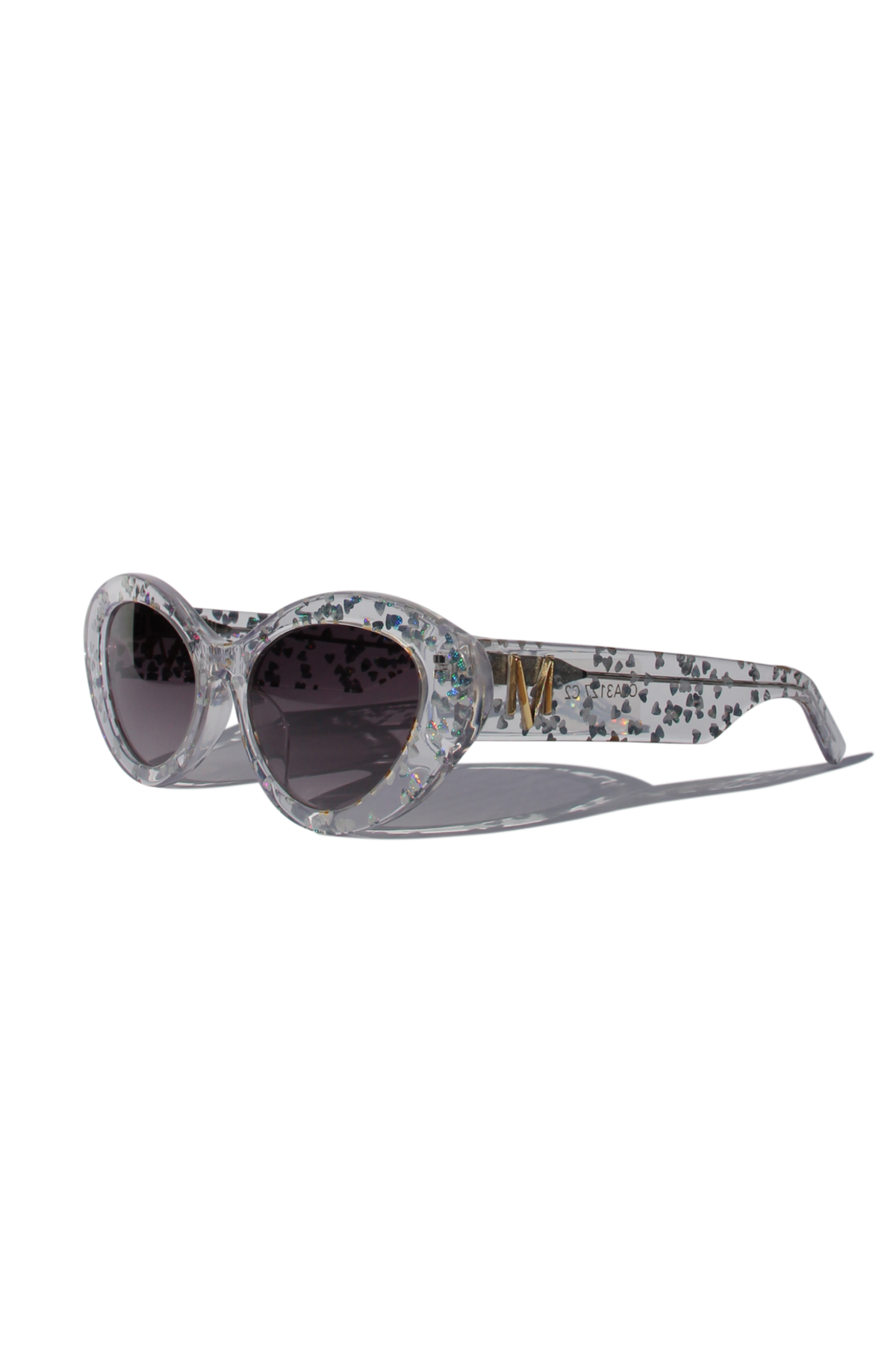 SILVELLE ~ Oval shaped sunglasses in clear acetate sprinkled with iridescent silver love heart sequins